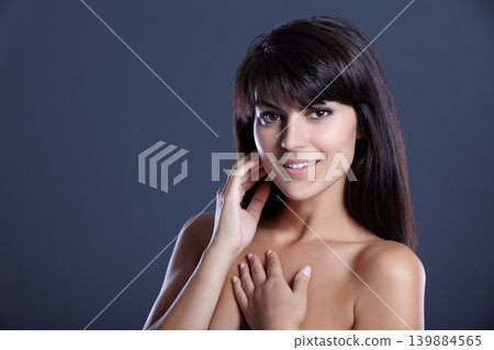 Beauty, skincare and portrait of happy woman with skin glow, natural makeup and studio mockup. Smile, dermatology and cosmetics with face of confident girl isolated on dark blue background space. Beauty, skincare and portrait of happy woman with skin glow, natural makeup and studio mockup. Smile, dermatology and cosmetics with face of confident girl isolated on dark blue background space. 139884565