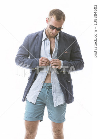 Fashion, button and man in studio with clothes, trendy blazer, stylish outfit for a col aesthetic. Wearing, confidence or male model with a fancy style or edgy sunglasses isolated on white background Fashion, button and man in studio with clothes, trendy blazer, stylish outfit for a col aesthetic. Wearing, confidence or male model with a fancy style or edgy sunglasses isolated on white background 139884602
