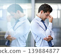 Headache, tired and business man with stress, burnout and anxiety for financial crisis in office. Frustrated, depression and serious professional with fatigue, sick and fail challenge with mistake 139884877