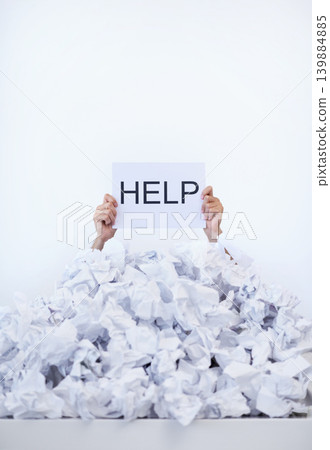 Person, desk and hands with pile of paperwork, sign and help with burnout, stress and administration. Debt, bills and worker lost in documents, overworked and overwhelmed with pressure in office. 139884885