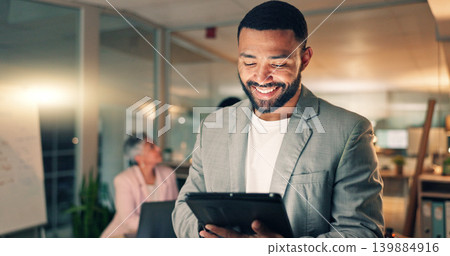 Tablet, meeting and happy business man in office, working on research project, schedule and planning. Night, corporate and worker on digital tech laugh for internet, website review and social media 139884916