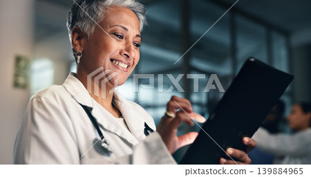 Doctor, mature woman and happy with tablet in night, typing or smile for results, meme or notification in hospital. Senior nurse, digital touchscreen or funny video with click, scroll or social media Doctor, mature woman and happy with tablet in night, typing or smile for results, meme or notification in hospital. Senior nurse, digital touchscreen or funny video with click, scroll or social media 139884965