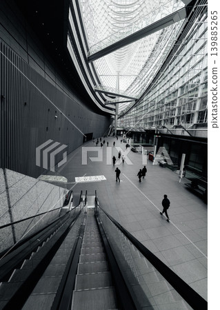 A monochrome scene of people passing through the glass building of the Tokyo International Forum. A monochrome scene of people passing through the glass building of the Tokyo International Forum. 139885265