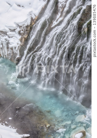 The silky flow of Shirahige Falls and a winter valley captured with a slow shutter speed. The silky flow of Shirahige Falls and a winter valley captured with a slow shutter speed. 139885476