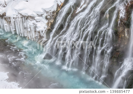Beautiful winter scenery of Shirahige Falls with snow and icicles (vertical orientation) Beautiful winter scenery of Shirahige Falls with snow and icicles (vertical orientation) 139885477