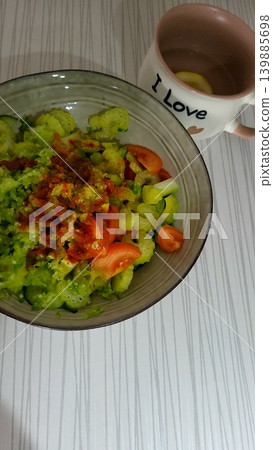 Close up of a healthy salad with greens and tomatoes in a bowl, nutritious organic food, lifestyle wellness. Close up of a healthy salad with greens and tomatoes in a bowl, nutritious organic food, lifestyle wellness. 139885698