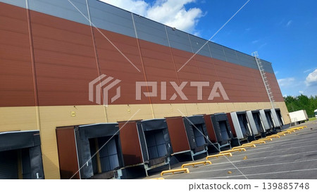 Exterior view of modern industrial loading docks at a distribution center, warehouse infrastructure research, urban logistics study. Exterior view of modern industrial loading docks at a distribution center, warehouse infrastructure research, urban logistics study. 139885748