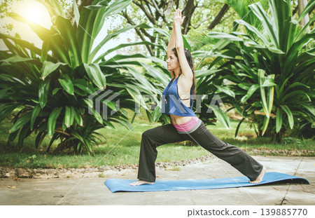 Beautiful woman doing yoga outdoors. Girl performing flexibility yoga 139885770