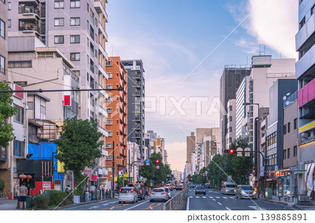 The cityscape and sunset are bathed in the beautiful gradient of colors at dusk. The cityscape and sunset are bathed in the beautiful gradient of colors at dusk. 139885891