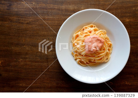 Tagliatelle with cod roe cream pasta, viewed from directly above the table background. Tagliatelle with cod roe cream pasta, viewed from directly above the table background. 139887329