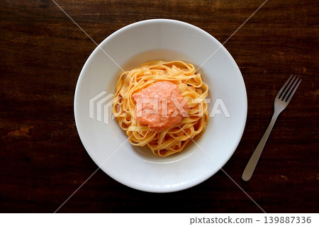 Tagliatelle with cod roe cream pasta, viewed from directly above the table background. Tagliatelle with cod roe cream pasta, viewed from directly above the table background. 139887336
