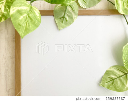 Eco-friendly, organic, and natural wood-framed whiteboards featuring the greenery of houseplants - perfect for writing and designing. Eco-friendly, organic, and natural wood-framed whiteboards featuring the greenery of houseplants - perfect for writing and designing. 139887387