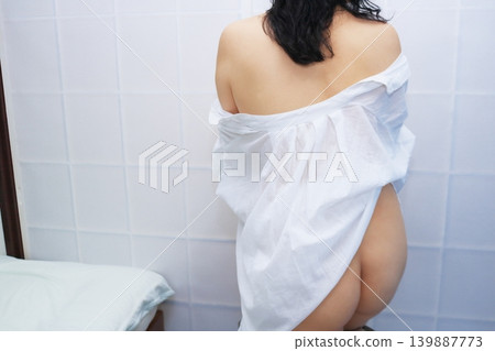 The back view of a woman wearing a dress The back view of a woman wearing a dress 139887773