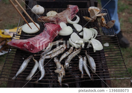 4 servings of seafood grilled over charcoal on a barbecue grill 4 servings of seafood grilled over charcoal on a barbecue grill 139888073