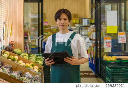 Male clerk working at the supermarket Male clerk working at the supermarket 139889021