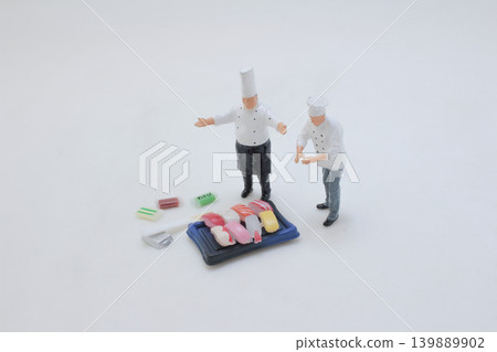 Chefs preparing sushi dish in miniature scene Chefs preparing sushi dish in miniature scene 139889902