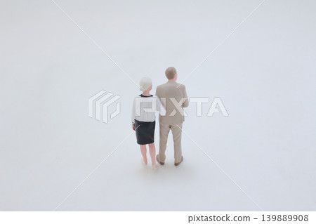 Miniature elderly couple walking together arm in arm Miniature elderly couple walking together arm in arm 139889908