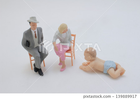 Miniature family scene with seated figures and baby Miniature family scene with seated figures and baby 139889917