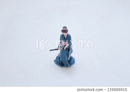 a Miniature traditional figure holding sword kneeling pose 139889918