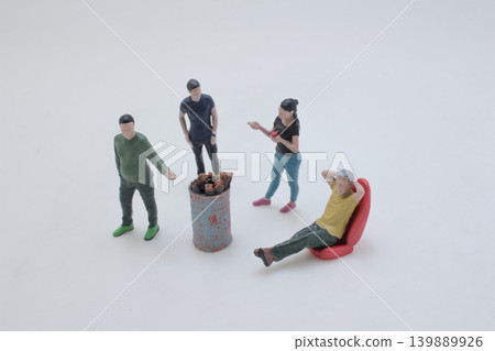 Miniature figures gathered around barrel fire scene Miniature figures gathered around barrel fire scene 139889926