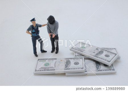 Police arrest suspect beside stacks of cash Police arrest suspect beside stacks of cash 139889980