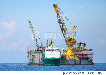 Rig along side the offshore platform for operation. Oil and gas industry in the gulf or the sea for operation. Maintenance and operation service with the construction platform by engineer. 139890055