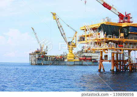 Rig along side the offshore platform for operation. Oil and gas industry in the gulf or the sea for operation. Maintenance and operation service with the construction platform by engineer. 139890056