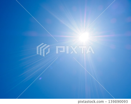 The dazzling summer sun shines brightly in the blue sky The dazzling summer sun shines brightly in the blue sky 139890093