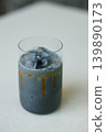 Cup of creation coffee with black charcoal drink on table. 139890173