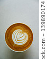Cup of hot milk latte coffee with heart shape latte art on table. 139890174