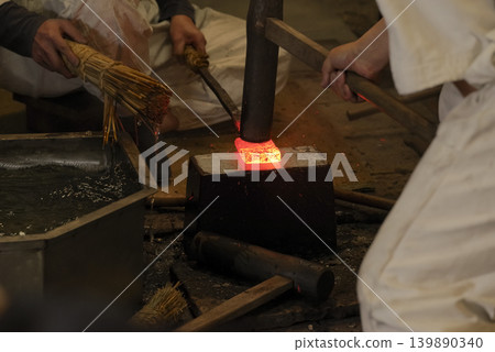 Japanese blacksmiths forging red-hot iron Japanese blacksmiths forging red-hot iron 139890340