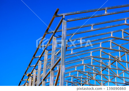 Workers are constructing steel beams frame for assembly building Workers are constructing steel beams frame for assembly building 139890860