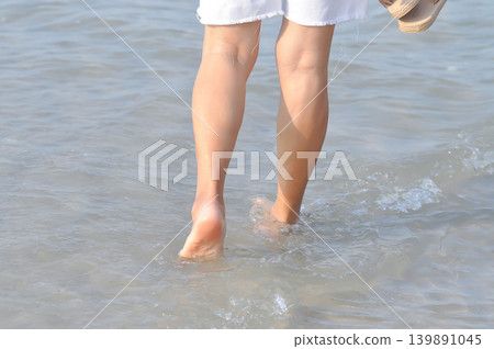walking on the beach, beach and sand or sea or leg and feet 139891045