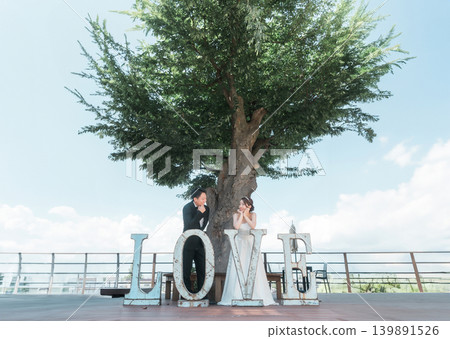 A bride and groom taking wedding photos in front of the LOVE sculpture A bride and groom taking wedding photos in front of the LOVE sculpture 139891526