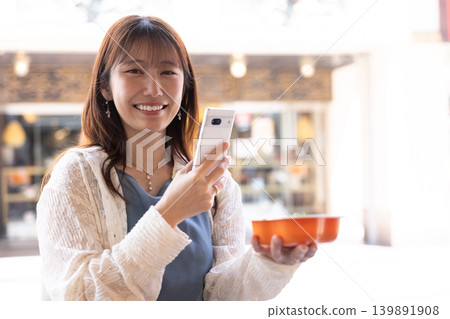 A woman enjoying street food in Yokohama Chinatown A woman enjoying street food in Yokohama Chinatown 139891908