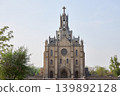 Roman Catholic church of the Sacred Heart of Jesus in Tashkent. Gothic architecture building with tall spire and cross. Religious landmark and cathedral for christian worship. 139892128