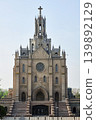 Roman Catholic church of the Sacred Heart of Jesus in Tashkent. Gothic style architecture with stone facade and steeple tower. Religious building landmark in Uzbekistan. Heritage site. 139892129