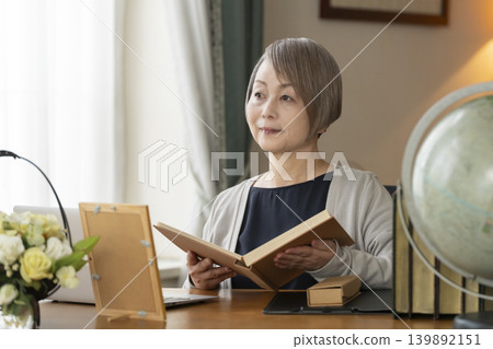 Senior woman working remotely from her home office Senior woman working remotely from her home office 139892151