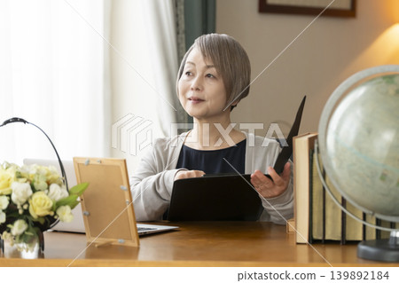 Senior woman working remotely from her home office Senior woman working remotely from her home office 139892184