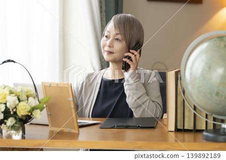 Senior woman working remotely from her home office Senior woman working remotely from her home office 139892189