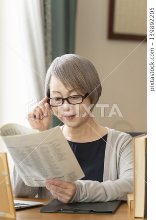 Senior woman working remotely from her home office 139892205