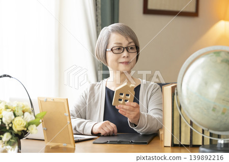 Senior woman working remotely from her home office Senior woman working remotely from her home office 139892216