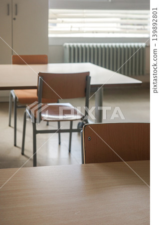 Empty Classroom With Wooden Desks And Chairs Empty Classroom With Wooden Desks And Chairs 139892801