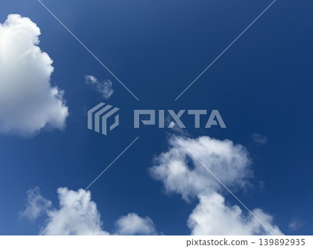 Pure white clouds floating in a bright blue sky / The sky Pure white clouds floating in a bright blue sky / The sky 139892935