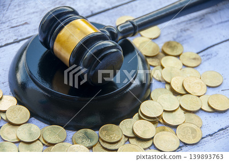 Judge gavel with coins representing legal and financial matters Judge gavel with coins representing legal and financial matters 139893763