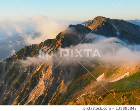Morning glow over Mt. Shakushi and Mt. Hakuba Yarigatake, viewed from Mt. Hakuba in the Northern Alps during summer. Morning glow over Mt. Shakushi and Mt. Hakuba Yarigatake, viewed from Mt. Hakuba in the Northern Alps during summer. 139893842