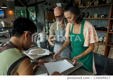 A happy couple makes ceramic plates in a workshop A happy couple makes ceramic plates in a workshop 139894027