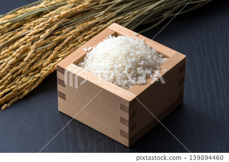 White rice and rice stalks in a measuring box White rice and rice stalks in a measuring box 139894460