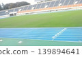 A beautiful athletics stadium with a blue track and a green field. We bring you a refreshing scene of sports. 139894641