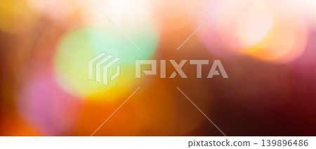 Colorful bokeh background with glowing mint pink and warm orange defocused lights for magical festive backdrop 139896486